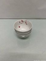 Stack of three matching porcelain bowls showing exterior and interior design