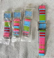 Four watches, three sealed, one displayed
