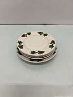 Stack of five matching floral fine china saucers, top view