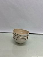 Stack of five beige Mikasa bowls