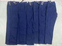 Seven pairs of dark navy QQMY jeans lined up showing tags and overall condition