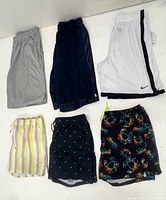Six pairs of shorts laid out top and bottom rows showing colours and patterns