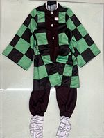 Full view of complete Tanjiro Kamado child XL costume set laid flat: haori, inner garments, leg wraps
