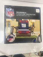 Front of box showing NFL licensed New York Giants reversible furniture protector for recliners