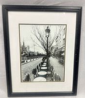Framed black-and-white photograph in black frame with mat
