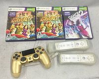 All items: gold PS4 controller, two Wii remotes in sleeves, two Kinect Adventures! cases, one Dance Central 2 case
