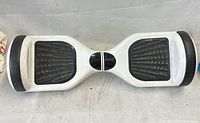 Top view of entire white hoverboard showing foot pads and overall wear