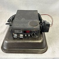 Front view of CB radio on mounting tray with microphone and wiring