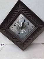 Front view of Seth Thomas wall clock showing carved wood frame and ornate dial