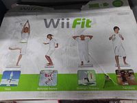 Front of Wii Fit retail box showing branding and activity imagery, visible wear and tear