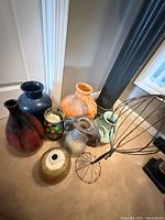 Group shot of seven assorted vases and metal wire stand
