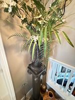 full view urn on pedestal with flowers