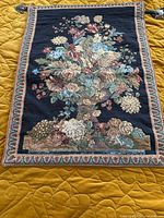 Front view of floral tapestry showing design and border