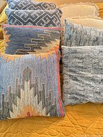 Assorted pillows stacked showing all four patterns