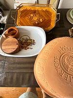 Grouped view showing Romertopf lid, enamel dish, wood mortar, condiment box and inlaid tray