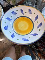 Round bowl with yellow center and blue leaf motif