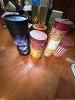 Group shot showing tall floral tube, round floral boxes, cork-print and striped cylinders