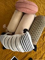 Five pillows grouped showing variety of shapes and colors