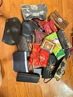Pile view showing variety of wallets, clutches, pouches