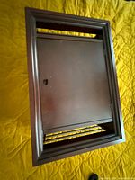 Front view showing closed drop-down door within framed top