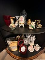 Shelf with multiple decorative items top and bottom tiers