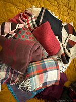Pile of assorted scarves showing variety of colors, patterns and textures