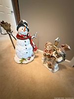 Single resin snowman with broom and red scarf