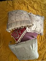All five pillows arranged together showing colors, patterns, trims
