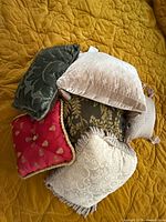 Group of six pillows showing variety of fabrics, colors and trims