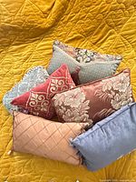 All six pillows stacked showing assorted colors and patterns