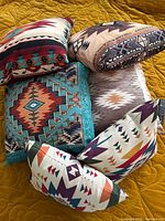 Six Southwestern style throw pillows displayed