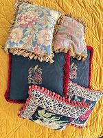 Overview of all six pillows showing three distinct designs and fringe styles