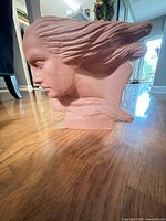 Side profile of terracotta female bust