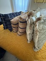 Group of six throw pillows showing patterns and colours
