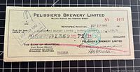 Full view of cheque front showing company name, date, amount, bank, cancellation marks