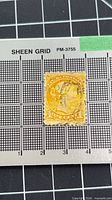 Front of the single Canadian 1¢ yellow-orange stamp on measurement grid