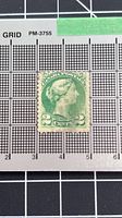 Front of Canada 2¢ Small Queen stamp with ruler grid for scale