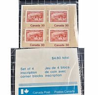 Front view of sealed stamp set showing four-block layout and packaging insert