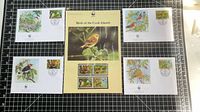Group shot showing all five pieces: four FDC envelopes around central folder