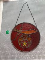 Full view of round stained glass Shriners Masonic suncatcher with hanging chain displayed on cutting mat