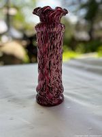 Full view of pink twisted confetti spatter vase standing upright