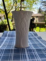 front view of white bisque Kaiser vase showing raised leaf relief pattern