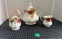 Full view of teapot, creamer and lidded sugar bowl
