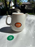 Side view showing Sanka logo, handle, lid