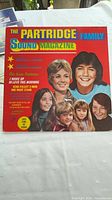 Front album cover with title, artist photos, catalog info