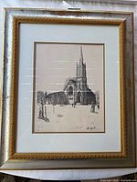 Framed print showing church exterior in metallic frame with mat