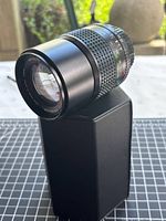 Front oblique view of Minolta 135 mm lens on stand