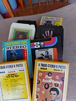 Front view showing eight-track cartridges including Three Dog Night and Elvis