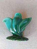 Front view of green Beauceware vase showing leaf motif and glaze