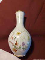 full view of porcelain bud vase with floral design